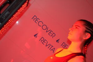 recover rejuvenate in front of a red light therapy panel