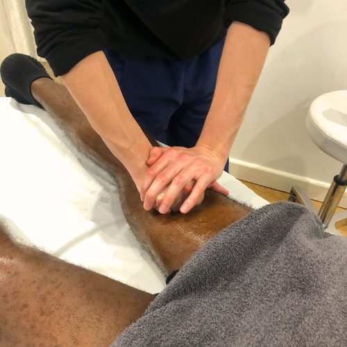 Male receiving sports massage on legs in sevenoaks cryojuvenate